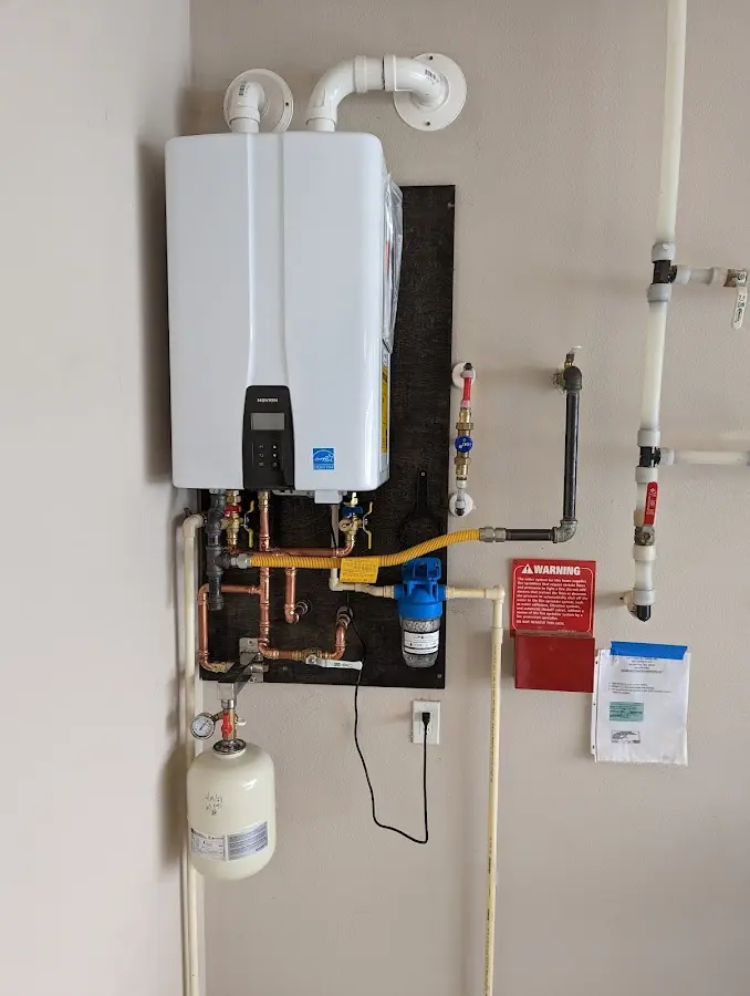 Professional plumber installing copper piping in a Belle Isle home